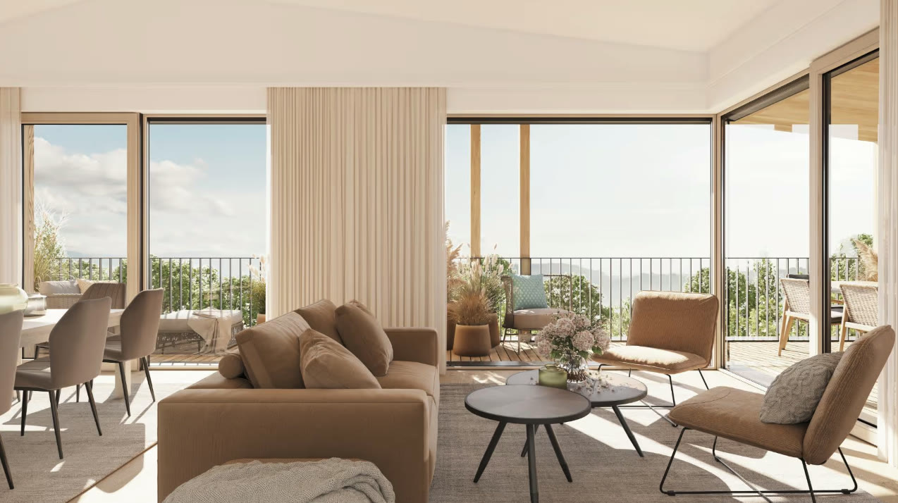 Wohnbauprojekte Weststeiermark — Wohnraum mit bodentiefen Fenstern und Blick auf die Terrasse